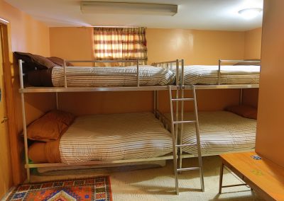 Two sets of bunk beds and ladder along with two dart boards in one bedroom at Murphy's Retreat Cottage