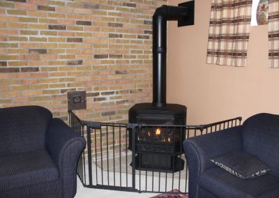 Cosy propane gas fireplace in basement.