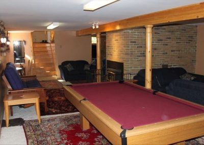 Games Room multi family resort in Ontario - image showing red top pool table in game room of Murphy's Retreat Cottage