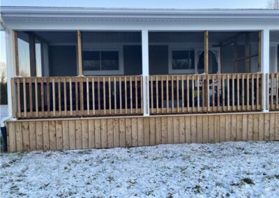 Discover Murphy's Retreat: The Ultimate Multi-Family Cottage Resort in Eastern Ontario - Image of front wooden deck with railings.