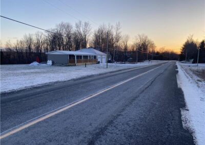 Large Cottage for rent that sleeps up to 46 with indoor pool. Located close to Cornwall, Ontario. Image shows paved road-highway leading up to Murphy's Retreat