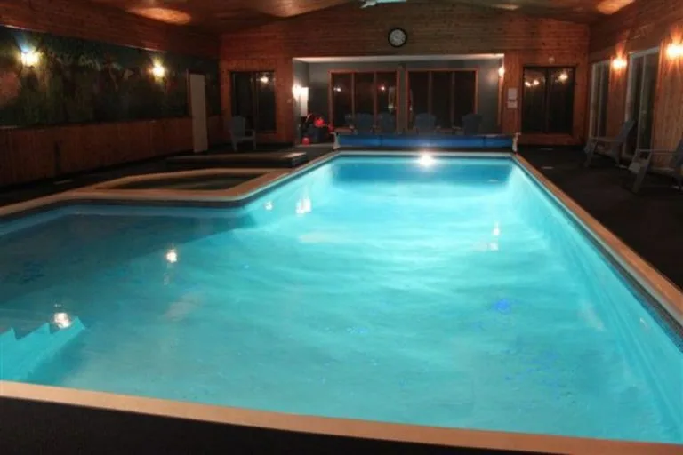 40 Ft Indoor Pool at night showing lights in pool - Multi Family Resort Cottage. Sleeps up to 46 people. Located in Eastern Ontario.